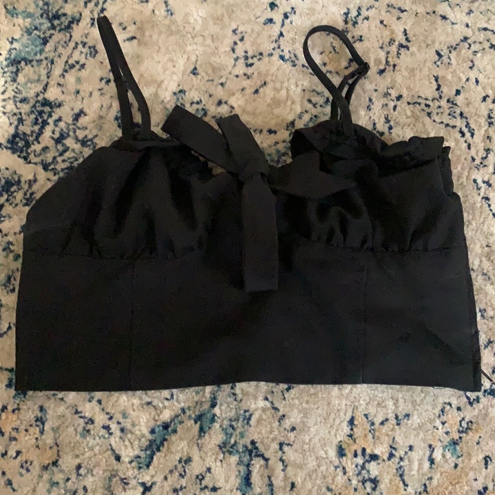 A cropped, tight top. Zipper on the side with a small bow on the front.